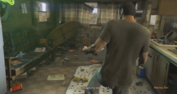 Trevor investigating his destroyed trailer.