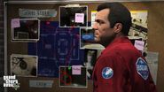 Michael wearing a Bugstars jumpsuit, infront of the robbery plan on Vangelico.