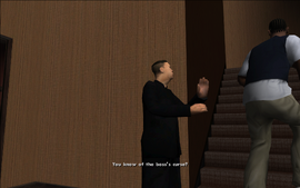 As Carl starts climbing the stairs, the henchman asks Carl if he knows about Woozie's "curse".