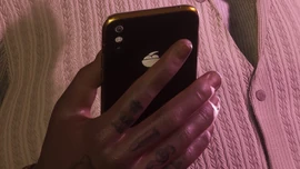 Boobie Ike holding a black iFruit phone in an official screenshot.