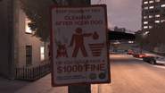 Sign requesting Liberty City residents to clean up after their dog unless they want to pay a $1000 fine.