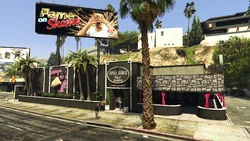 Front side of Split Sides West, with a  sign next to it