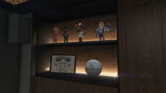 Another shelf in Franklin's office, featuring a framed drawing of the "We Missed You" graffiti in Chamberlain Hills.