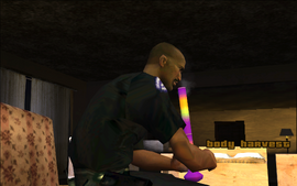 Tenpenny is hitting a bong in a motel room in Angel Pine.