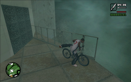 CJ stealing a bicycle left by the door to the mansion.