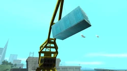 A shipping container lifted by a crane