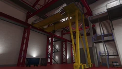 A large crane inside the hangar.