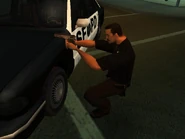 A San Fierro Police Department cop crouching and shooting with a pistol.