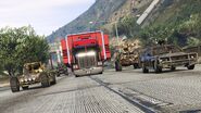 An escorted MOC being towed by a Phantom Custom in Grand Theft Auto Online.