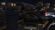 Franklin using the Carbine Rifle to steal a car.