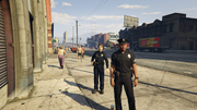 Male and female officers on foot patrol near Mission Row Police Station.