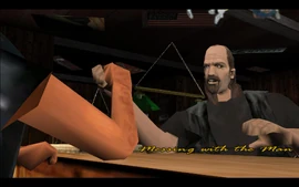 Mitch is winning an arm-wrestling match with one of his boys in the Greasy Chopper bar.