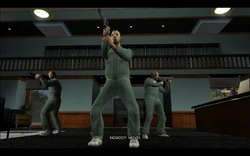 The crew walks into the bank and Tommy announces the raid.