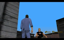 Suddenly, Phil comes running from around a corner and yells at Tommy to run as well.