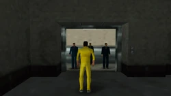Three armed Yakuza members surprise Toni inside the elevator.