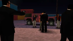 Two members of the Colombian Cartel come out of the Patriot. The Colombians and the Leones start aiming their guns at one another while Toni and Miguel stare at each other.