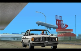 Meanwhile, at the Escobar International Airport in Vice City, a man is seen waiting for someone in his vehicle.