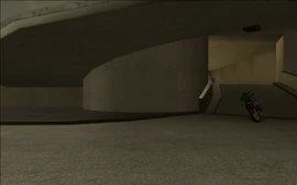 As CJ and Smoke drive through the multi-storey parking lot, the Russians start going after them.