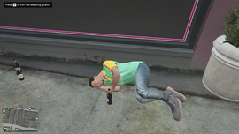The sleeping guard with a notification to loot him.