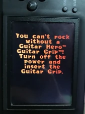 The message that appears when you try to play the game without the Guitar Grip.