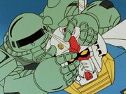 Cozun's Zaku attacks the Gundam's head.