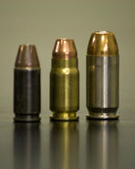 9mm, the cartridge furthest to the left, as compared to a .357 SIG cartridge and a .45 ACP cartridge