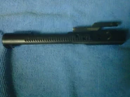 A semi-automatic AR-15 bolt carrier. Note the rear part of the bottom of the carrier; there is not enough metal to engage an auto sear.