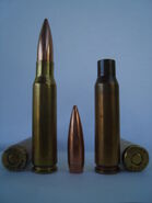 Left: .308 Winchester headstamp and cartridge. Center: 155 gr (10 g)Palma bullet. Right: 1971 Lake City, Match ammo headstamp and empty 7.62x51mm NATO round brass.