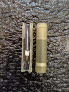 5.56×45mm SCF cutaway (minus gunpowder) next to complete round.