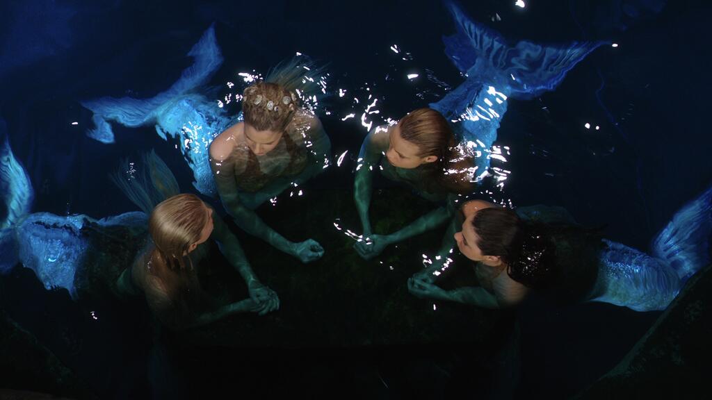 The mermaids now have possession of the trident and hide it. 