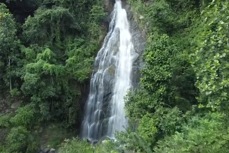 A seasonal waterfall cascading down the forested slopes of Morne Grand-Gilles
