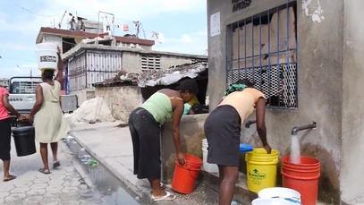 Residents receive Aquatabs along with their purified drinking water