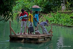 Youths use a basic ferry to cross the river; Abricots, 