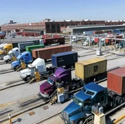 Container-truck logistics, similar to the freight systems that influence port activity at La Saline.
