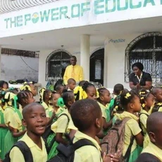 Morning lineup in Fontamara, where students gather in their signature green-and-yellow uniforms.