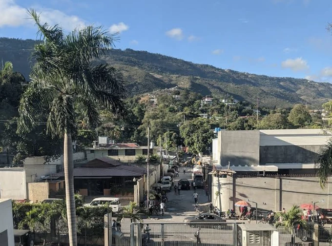 A calm interior road in Bois-Patate, with Morne l’Hôpital in the background.