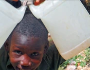Young man carrying water