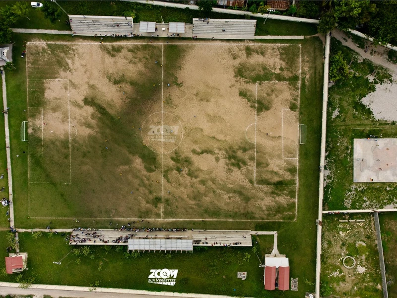 Overhead shot of Parc Michelet Destinoble, showing the full layout of the field and spectator stands.