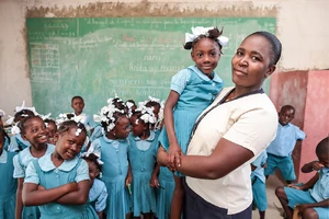 A teacher from Notre Dame de Lamerci de Robillard school, with her first grade students
