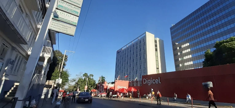 A calm day on Avenue John Paul II, with Digicel out front and the Marriott rising steady behind it.