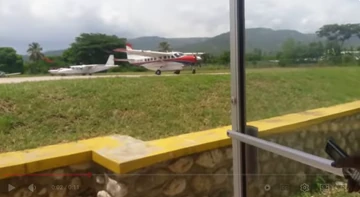 Light aircraft parked along the runway