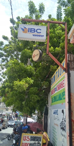 Nazon’s daily hustle, with change bureaus, international shipping, fast-food, and foot traffic moving nonstop along the main road.