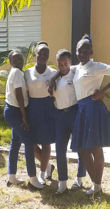 Group of secondary school students in Petit-Harpon standing outside a school building, 2022.