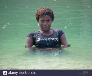Young-pretty-girl-bathing-in-a-river-haiti-grande-anse-abricots-CRGKY2
