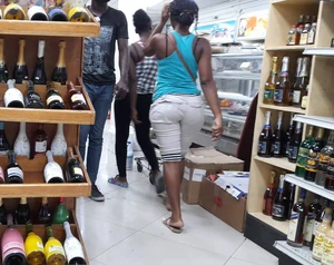 Urban residents moving through a local market in Nazon