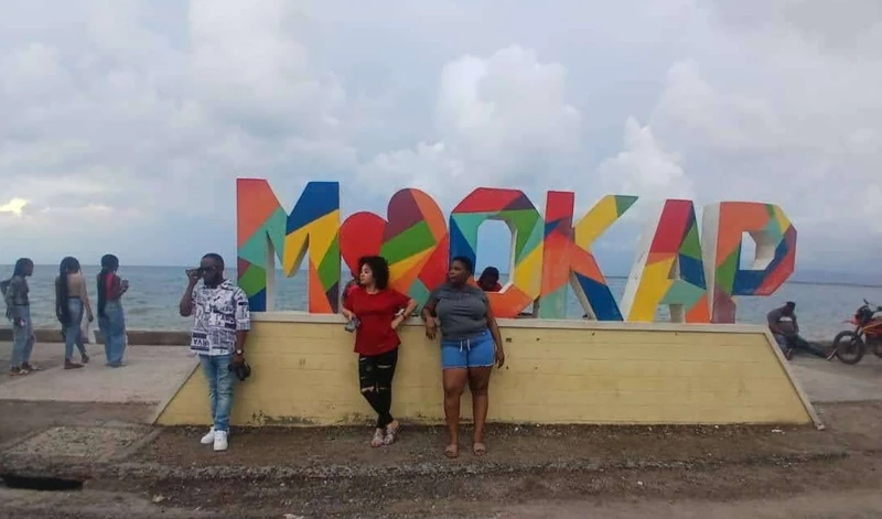 Residents and visitors gather near the Au Cap landmark on the waterfront. If it feels right, it’s probably OKAP.