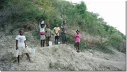 Children pose with water in an outer village of Jean-Rabel