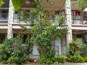 The quiet courtyard of Baillergeau's Rollanda Hotel, framed by stone columns and lush garden plants.