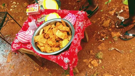 Street-side fritay in Goyavier — freshly fried snacks served from a small table, a familiar everyday sight in the communal countryside.