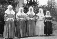 1921. Nuns, posing in front of a convent. in addition to Haitian nuns, nuns came from France, Switzerland, Spain, Italy, Belgium, and settled in Haiti, and educated the children. Lots of schools were ran by them.